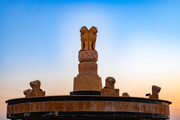 indian national emblem with bright dramatic sky at evening from different angle