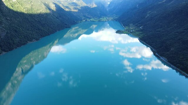 Flying towards Briksdalsbreen glacier over Oldevatnet lake in Norway. Drone footage