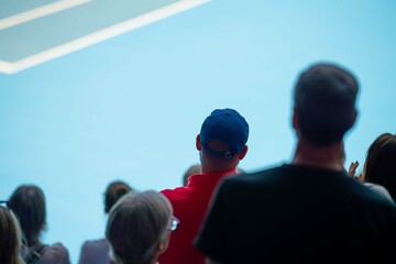tennis fan watching a tennis match at the australian open eating food and drinking in an arena - obrazy, fototapety, plakaty