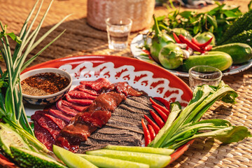 Traditional food in Thailand, Thai local food menu with raw food ingredient in the local name of Soi Ju, Sajin, Laab, koy, Soy Ju, raw meat with chili spicy sauce over dish on table background