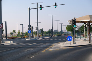 Empty road highway with roadsigns and green traffic light