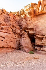 Fantastically beautiful landscape in the national nature reserve - Red Canyon in the rays of the setting sun, near the city of Eilat, in southern Israel