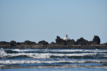 Oregon coastal range with lighthouse in the background.