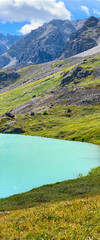 Panorama mountain lake calm turquoise with clear water Karakabak in the Altai mountains under thick clouds during the day. Vertical frame.