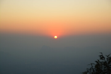 Beautiful scenery of the sunrise and sun from Pha Nok Aen cliff of Phu kradueng national park, Thailand.
