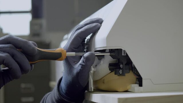 Electric Technician Wearing Gloves Unscrews Air Conditioner Part