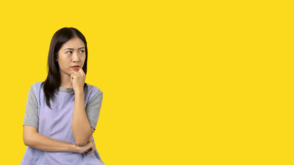 Young Asian woman thinking hard or planning to do something, Overthinking or worrying, Have a headache, Migraine, Stress, Free space for advertising or promoting products, Copy space, Enter text.