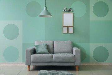 Interior of modern room with sofa near mint wall
