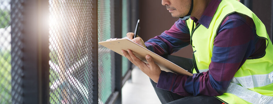 Home inspection consultancy. Inspector checking material of balcony and looking for fracture.