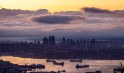 Fototapeta premium Developed city with industrial and residential buildings. Clouds in Background. Vancouver, British Columbia, Canada. Sunrise Sky