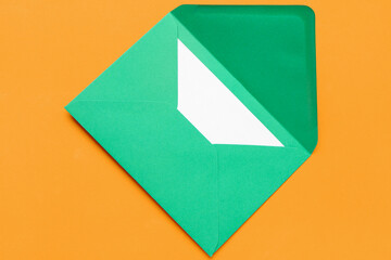 Green envelope with card on color background