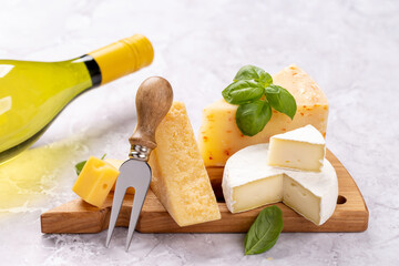 Various cheese on board and white wine