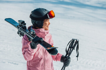 Skiing. Skier woman athlete going skiing on slope ski piste wearing helmet and ski goggles in winter nature landscape. Winter sports active lifestyle