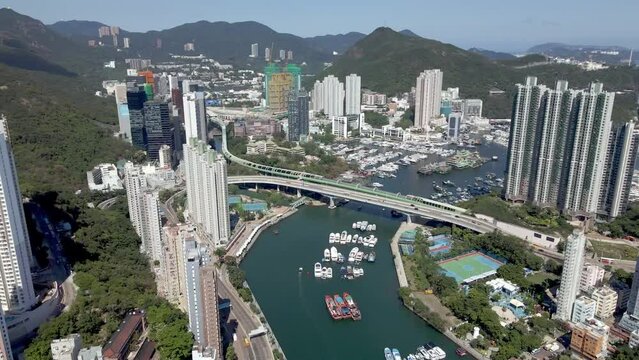 Aberdeen Hong Kong. Aerial view of the bay with boats, buildings, and skyscrapers. Mountains in the background. Popular destination in Asia, China. 