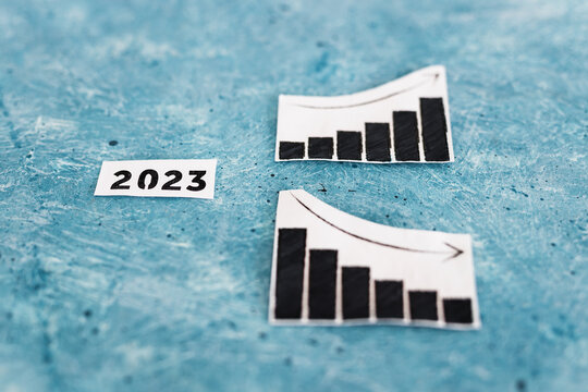 interest rates or inflation and cost of living concept, 2023 text with charts showing stats increasing and decreasing