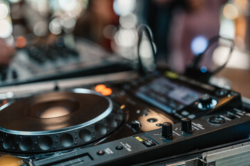 Obraz na płótnie Canvas DJ Spinning. mixing and scratching in a night club. DJ playing music at mixer. Closeup. Party. Dj playing music on rave party in nightclub. Disc jockey mix