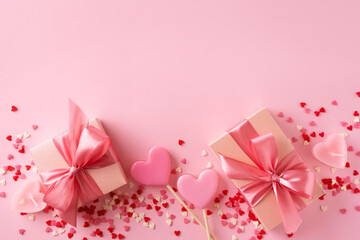 Candy pink lollipops with red gift box on pink background