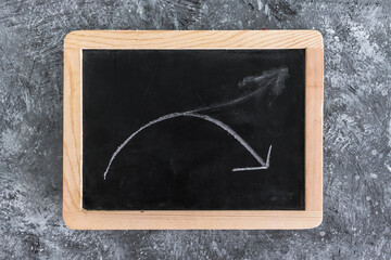 interest rates or inflation and cost of living, blackboard with arrow going down and arrow going up looking cancelled