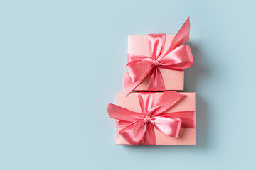 Pink gift box with bow on blue background
