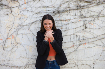 young beautiful woman leaning on a wall makes different expressions, sad, melancholic, happy, exhausted, dazed, smiling, thinking, tired. Concept different expressions.