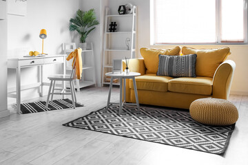 Interior of living room with yellow sofa near window