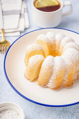 Plate with delicious cake and cup of tea on light background