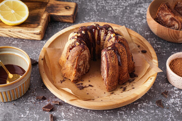 Wooden plate with delicious cake and hot chocolate on grunge background