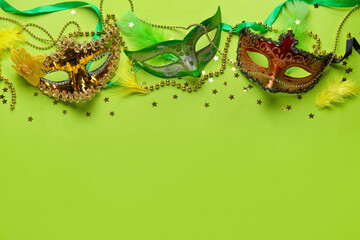 Carnival masks for Mardi Gras celebration with beads and stars on green background