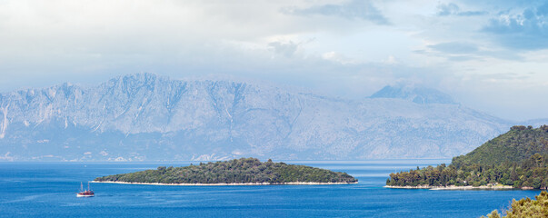 Beautiful hazy summer Lefkada coastline panorama (Nydri, Greece, Ionian Sea).