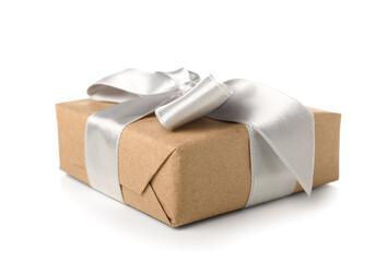 Gift box wrapped in craft paper with silk bow on white background