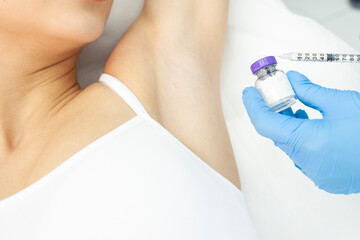 armpit botox procedure in cosmetology clinic, woman patient makes armpit botox injection