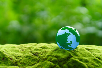 Globe Glass on green grass forest with sunlight. Environment, save world, earth day and...