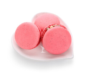 Heart-shaped plate with tasty macaroons isolated on white background. Valentine's Day celebration