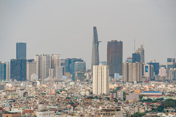 Fototapeta na wymiar Ho Chi Minh city, Vietnam - 20 Jan 2023: View from District 7 to the city center. See Bitexco tower and Landmark 81, IFC One,... famous towers in Vietnam. One of the developed cities in Vietnam.