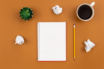 Empty notebook with cup of coffee and crumpled paper balls, flat lay.