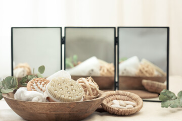 Spa composition with body care products on a blurred background with a mirror.