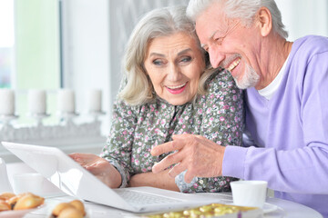 senior couple using laptop