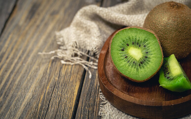 Close -up, cut fruit kiwi on a wooden background, rustic style.