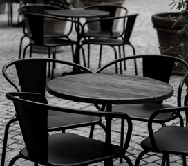 empty black tables and chairs of restaurant