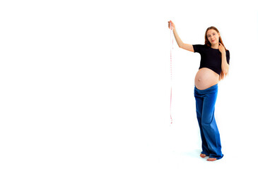 Pregnant woman measuring stomach with measuring tape