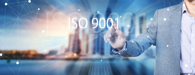 ISO 9001 concept. A man presses the screen.