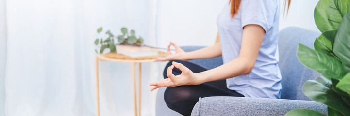 Young Asian healthy woman exercising with laptop at home