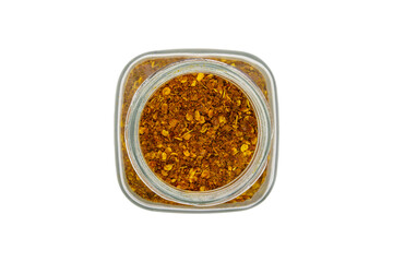 Chili powder in a glass jar, top view, isolated on white