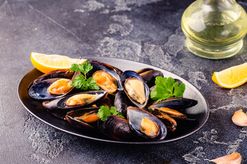 Delicious seafood mussels with sauce and parsley.