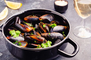 Delicious seafood mussels with sauce and parsley.