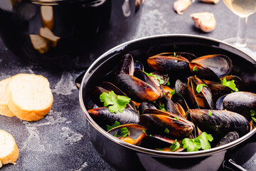 Delicious seafood mussels with sauce and parsley.