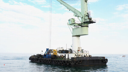 Fototapeta premium Marine load crane in Odessa sea port. Floating marine crane in Odessa Black Sea.