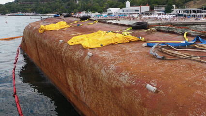 Sunken ship on the seashore. Rusty oil tanker.