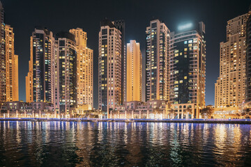 Fototapeta na wymiar Night view of high-rise buildings of residential district in Dubai Marina. Dubai Marina Towers. Dubai Marina Skyline Background. Holidays In United Arab Emirates. Vacation In UAE. Night view of high