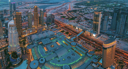 Fototapeta na wymiar Aerial View Of Evening Night Scenic View Of Skyscraper. Night Traffic In Residential District in Dubai. Street Night Illumination. Night Scenic View Of Dubai Skyline. High quality photo.